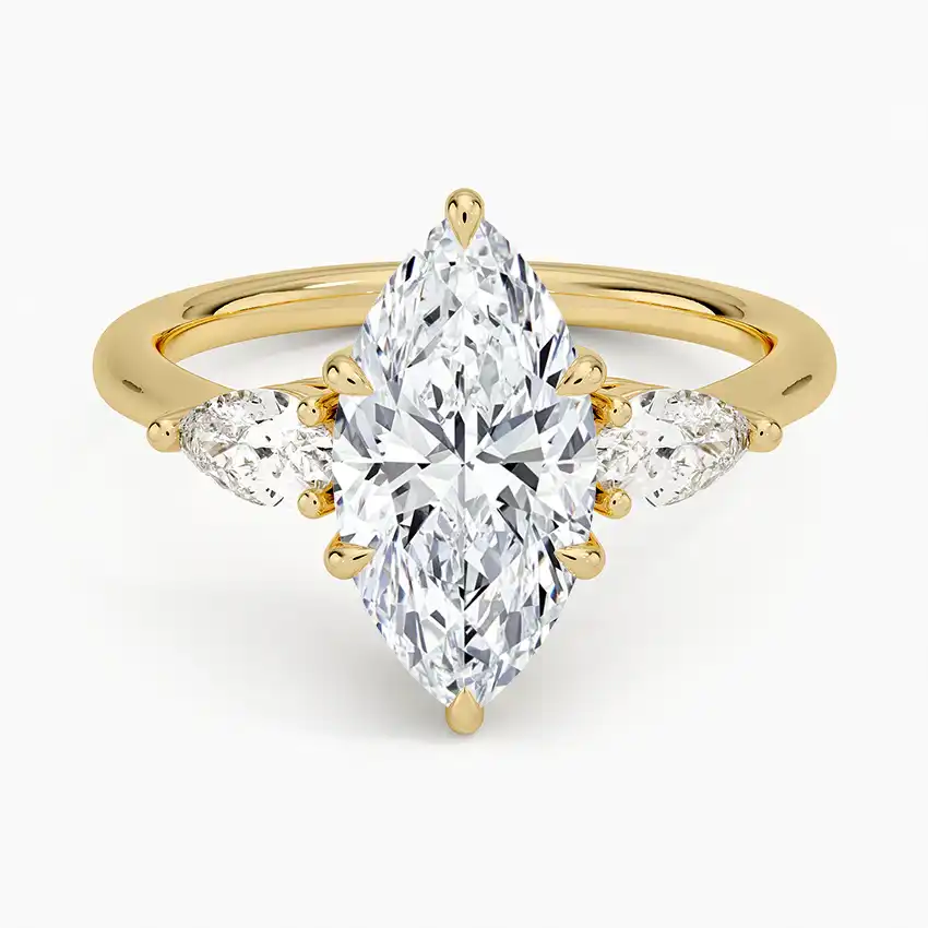 Marquise cut moissanite ring with side stones set in yellow gold