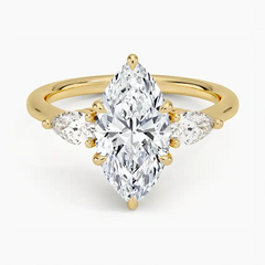 Marquise cut moissanite ring with side stones set in yellow gold
