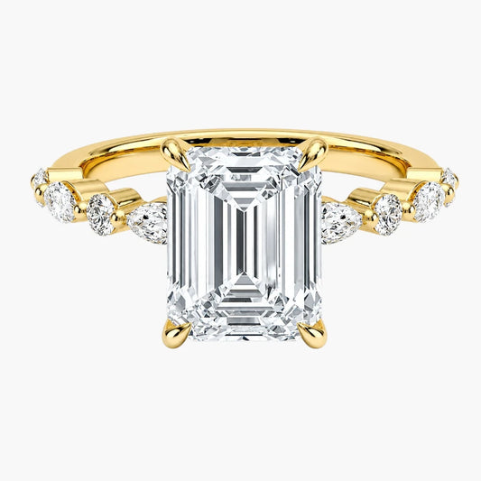 Emerald cut moissanite engagement ring with gold band and side accent stones