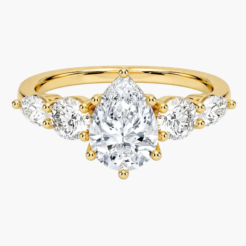 Elegant Pear Cut Moissanite Ring with Graduated Side Stones in Yellow Gold
